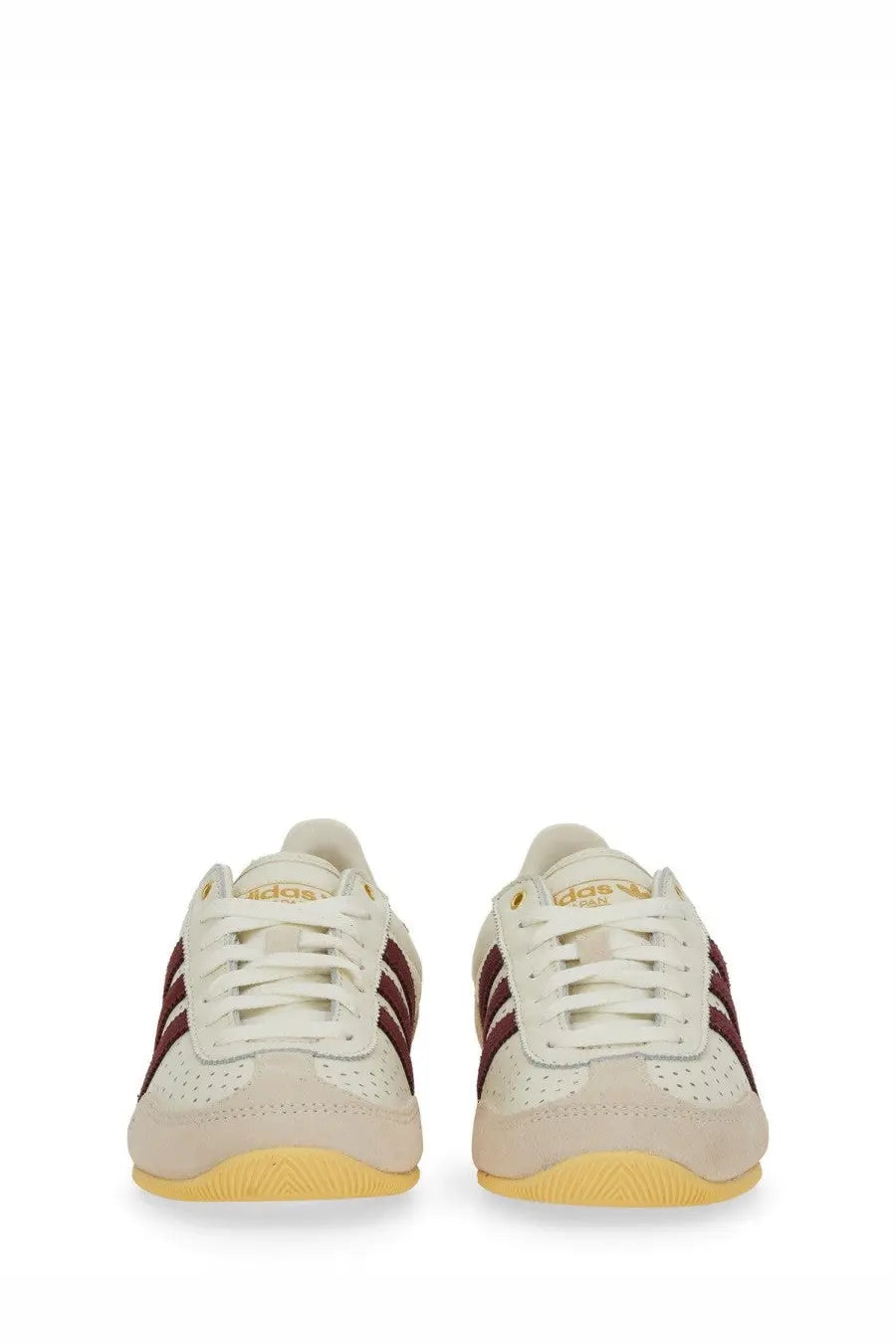 Cream-colored adidas women’s sneaker japan white with maroon stripes and yellow sole for casual wear