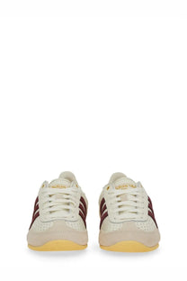 Cream-colored adidas women’s sneaker japan white with maroon stripes and yellow sole for casual wear