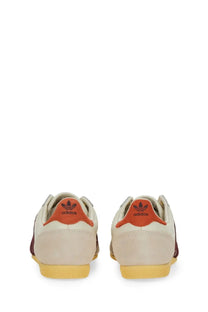 Cream-colored suede adidas women’s sneaker japan white with orange heel tabs and yellow rubber soles back view
