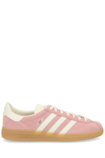 Adidas women’s sneaker muenchen blue featuring pink suede gazelle sneakers with white stripes and gum rubber sole