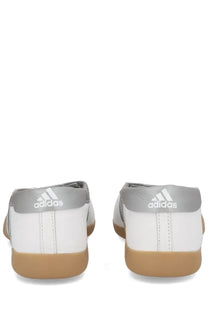 White and gray adidas women’s taekwondo mei sneaker with a gum-colored rubber sole for martial arts training