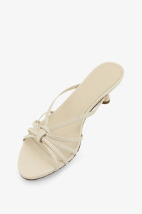 Aeyde women’s Abby leather sandals in cream with strappy design low heel and tied bow detail