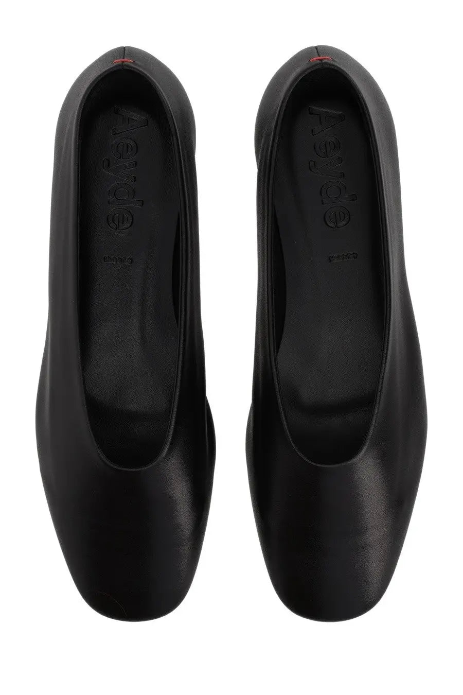 Black leather aeyde women’s dancer kirsten ballet flats with sleek minimalist design and red stitching at the heel back view