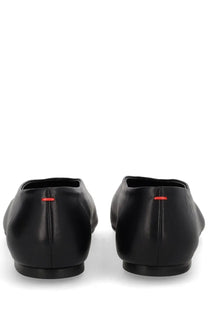 Aeyde women’s dancer Kirsten black leather ballet flats shown from the back with subtle red stitching detail at the heel