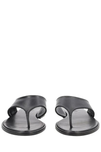 Aeyde women’s black leather thong sandal with minimalist design and sleek straps shown from front angle