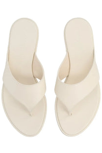 Cream-colored leather flip-flops with minimalist design and subtle stitching from Aeyde women’s leather thong sandal white