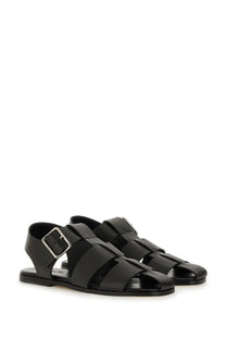 Aeyde women’s black leather sandals with woven strap design and silver-toned buckle for stylish wear