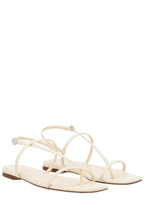 Aeyde women’s thong sandal ella white features cream-colored minimalist thin crisscrossing straps and flat sole