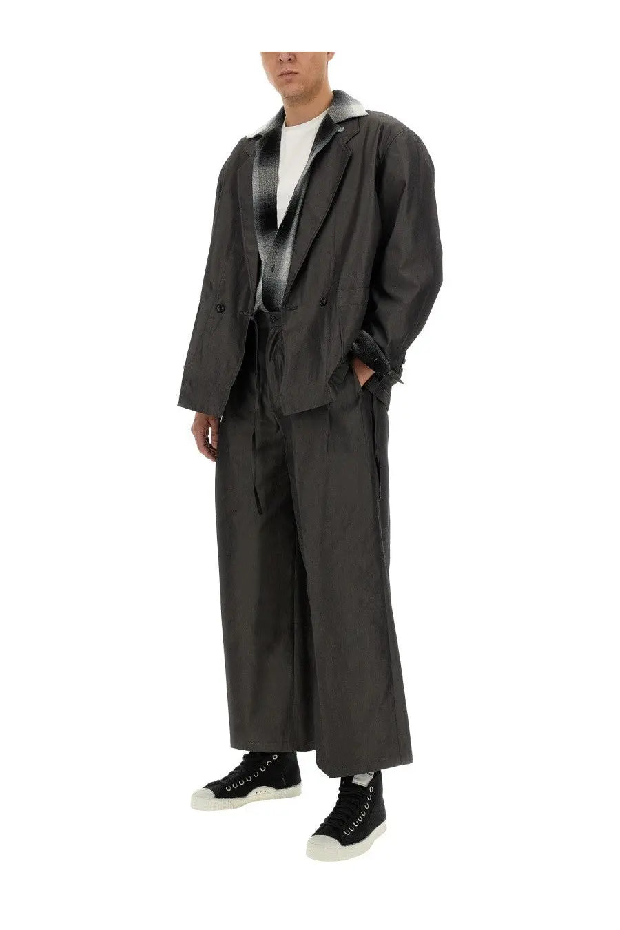 Aïe men’s white cotton shirt paired with a black trench coat featuring a silver-lined collar and double-breasted front