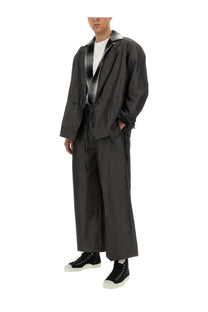 Aïe men’s white cotton shirt paired with a black trench coat featuring a silver-lined collar and double-breasted front