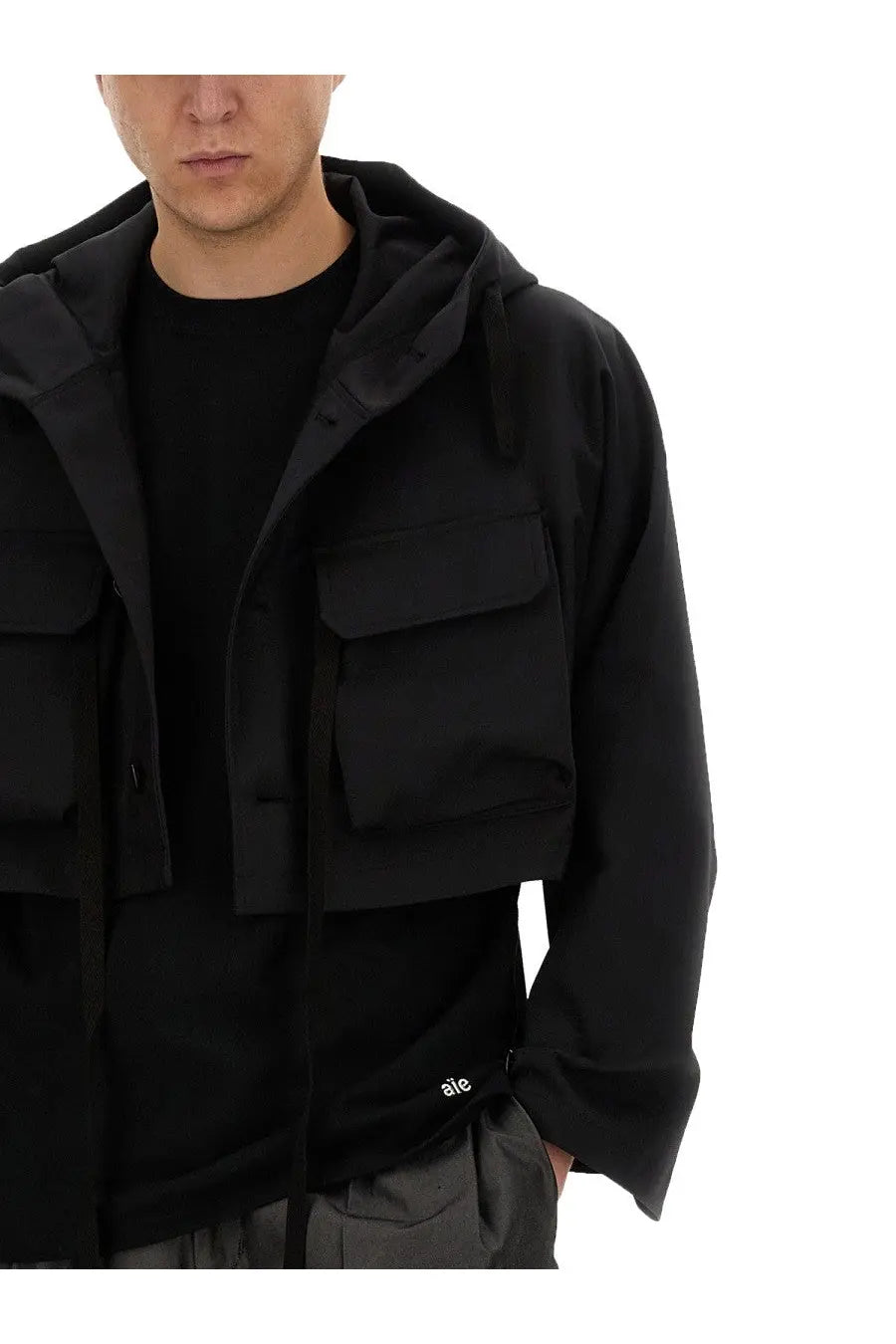 AïE men’s cropped black hooded jacket with multiple front pockets and a subtle brand logo on lower left side