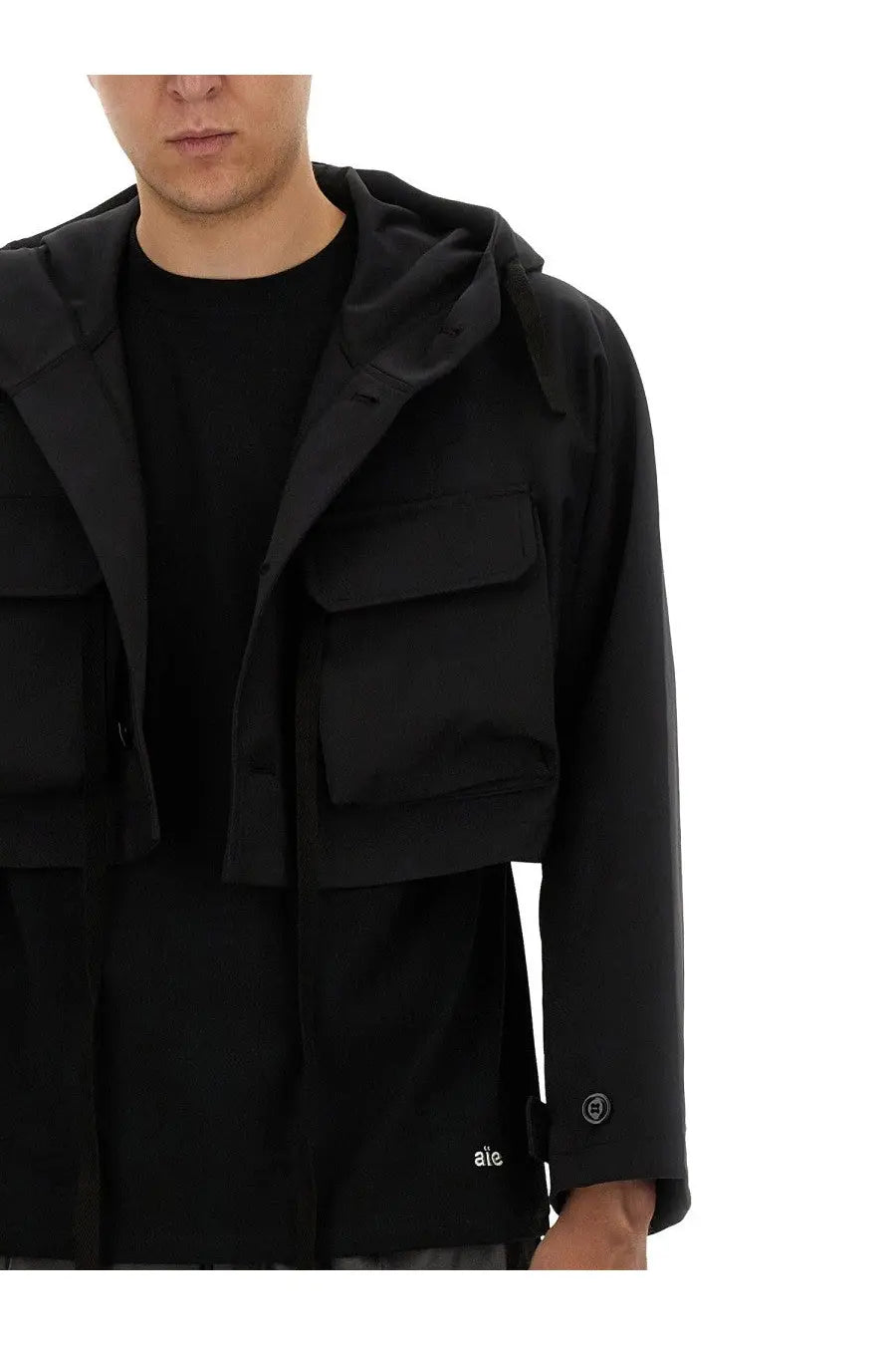 AïE men’s black jersey shirt with hood multiple flap pockets and subtle brand logo on the sleeve