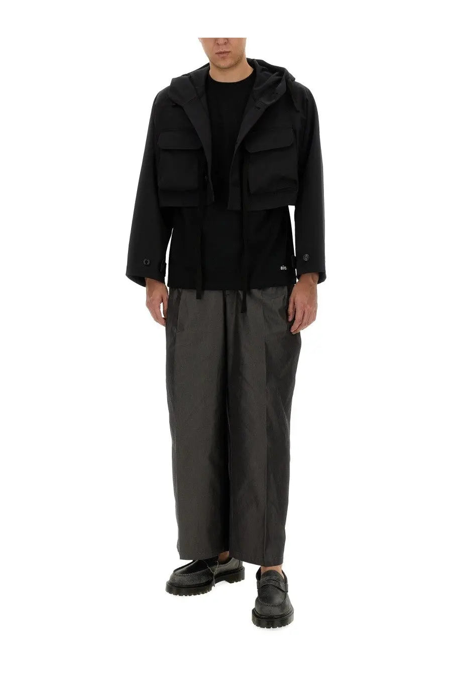 Aïe men’s black jersey shirt with sleek modern design and multiple flap pockets in a hooded jacket style