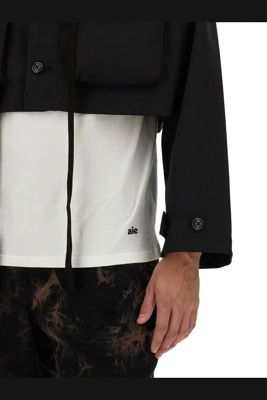 AïE men’s jersey shirt white featuring a black and white two-tone jacket design with subtle branding on the front panel