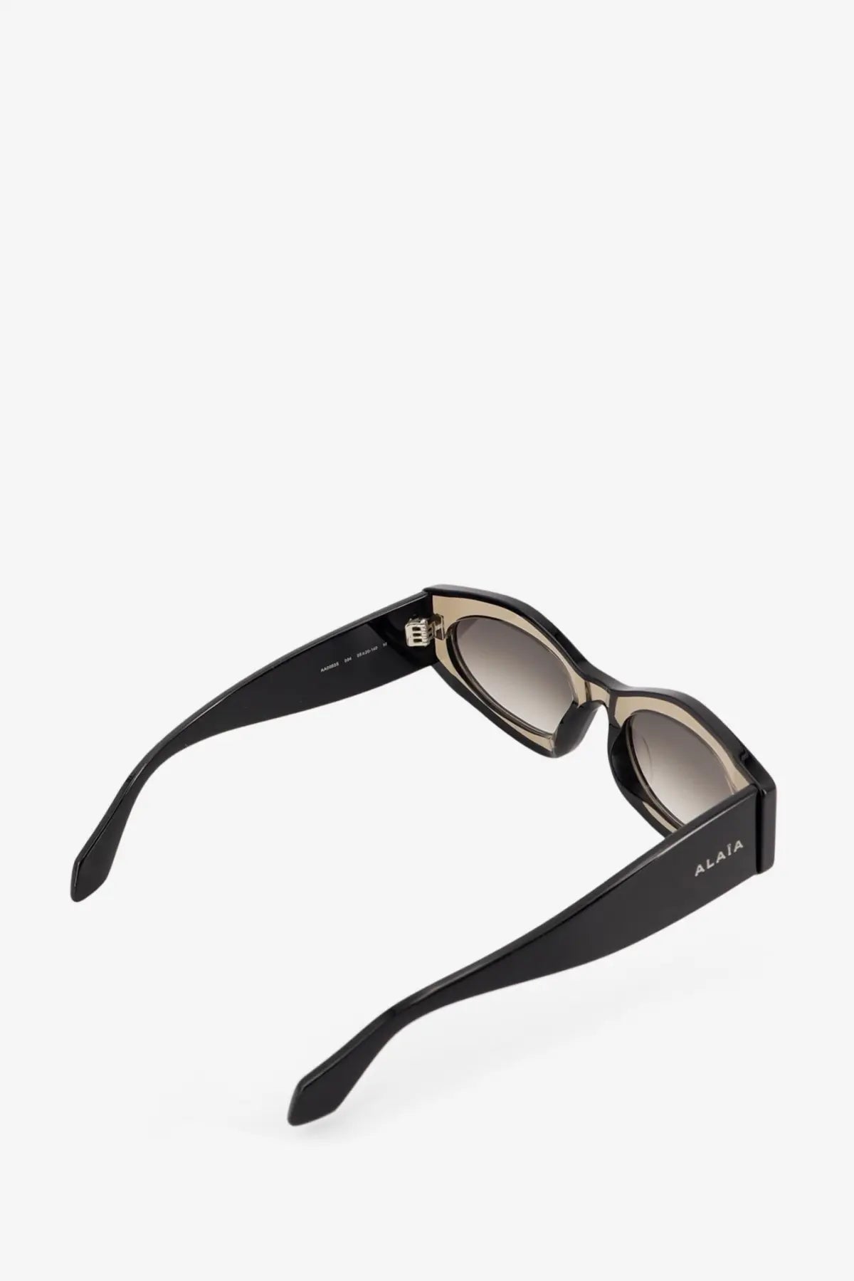 Alaïa women’s acetate sunglasses in black with gradient gray lenses and a sleek modern frame design