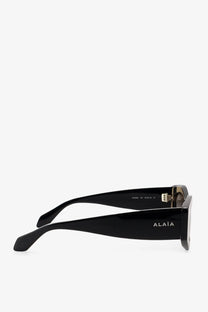 Alaïa women’s acetate sunglasses in black with a sleek rectangular frame and metallic temple hinges