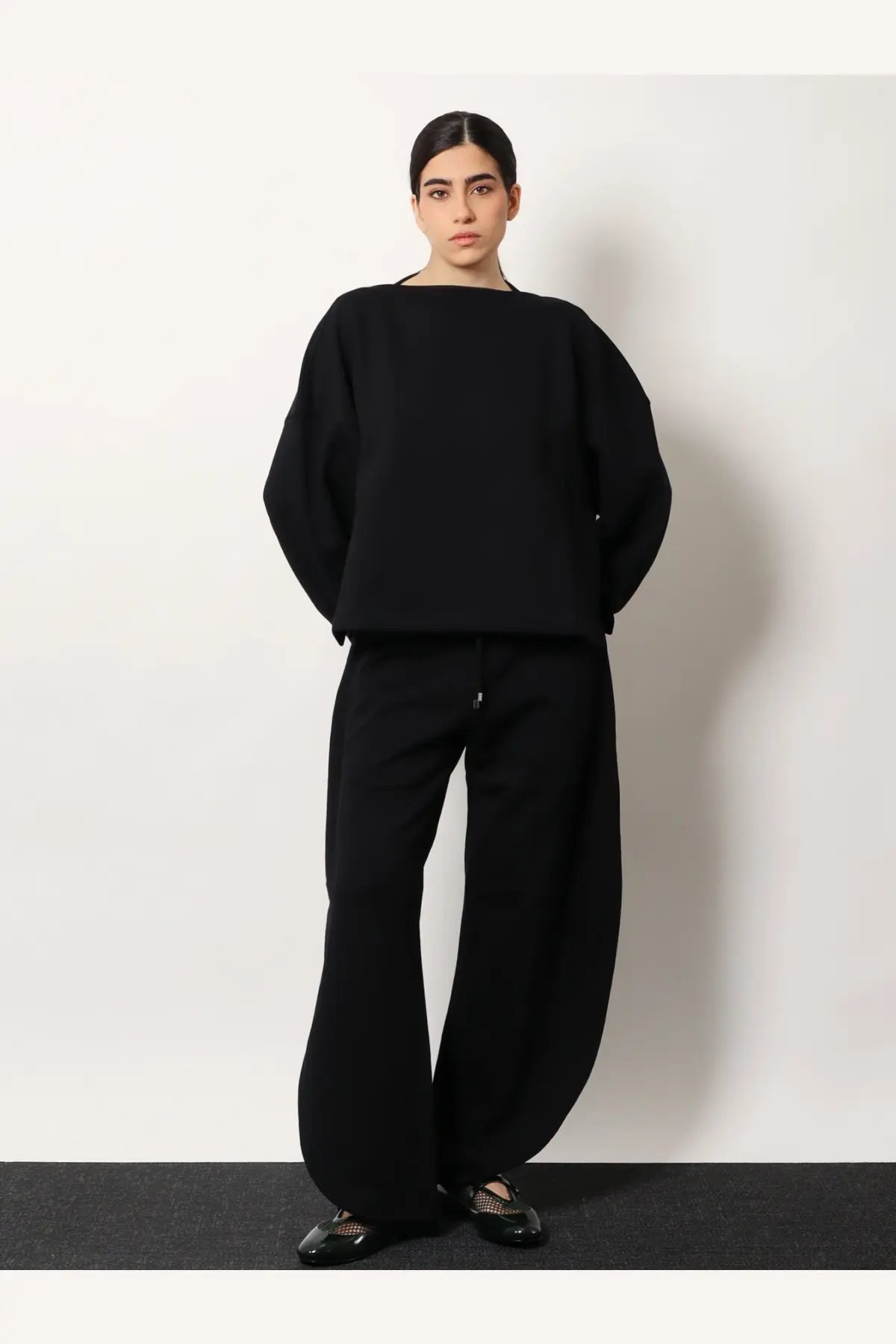 Alaïa women’s black oversized knit cotton sweater with wide sleeves and boat neckline front view