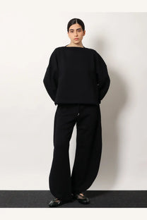 Alaïa women’s black oversized knit cotton sweater with wide sleeves and boat neckline front view