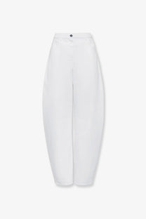 Alaïa women’s white high-waisted denim trousers with a sleek minimalist design and subtle front pleats