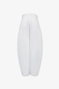 Alaïa women’s white high-waisted wide-leg denim trousers with smooth sleek fabric and subtle stitching details