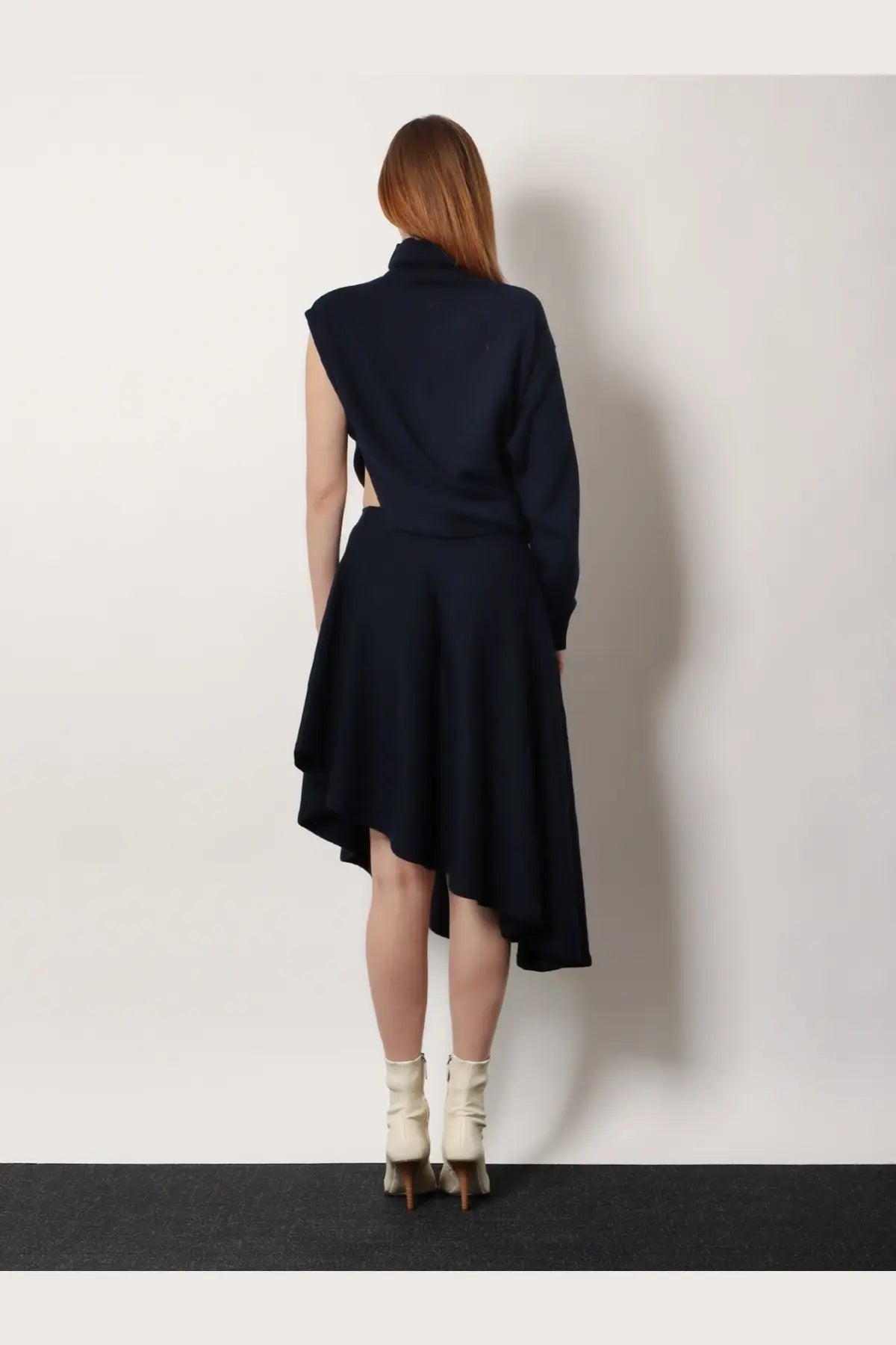 Alaïa women’s cut out virgin wool dress in navy blue with asymmetrical design high neckline long sleeves and flared skirt
