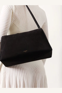 Alaïa women’s le bouledogue black nubuck shoulder bag with minimalist design and subtle alia embossing on front