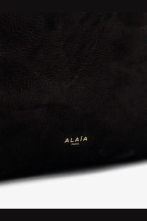 Black textured leather shoulder bag with gold foil alaïa paris branding for women