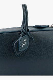 Dark blue leather ALAÏA women’s Le Teckel shoulder bag with matching handle and stitched Alaïa Paris tag
