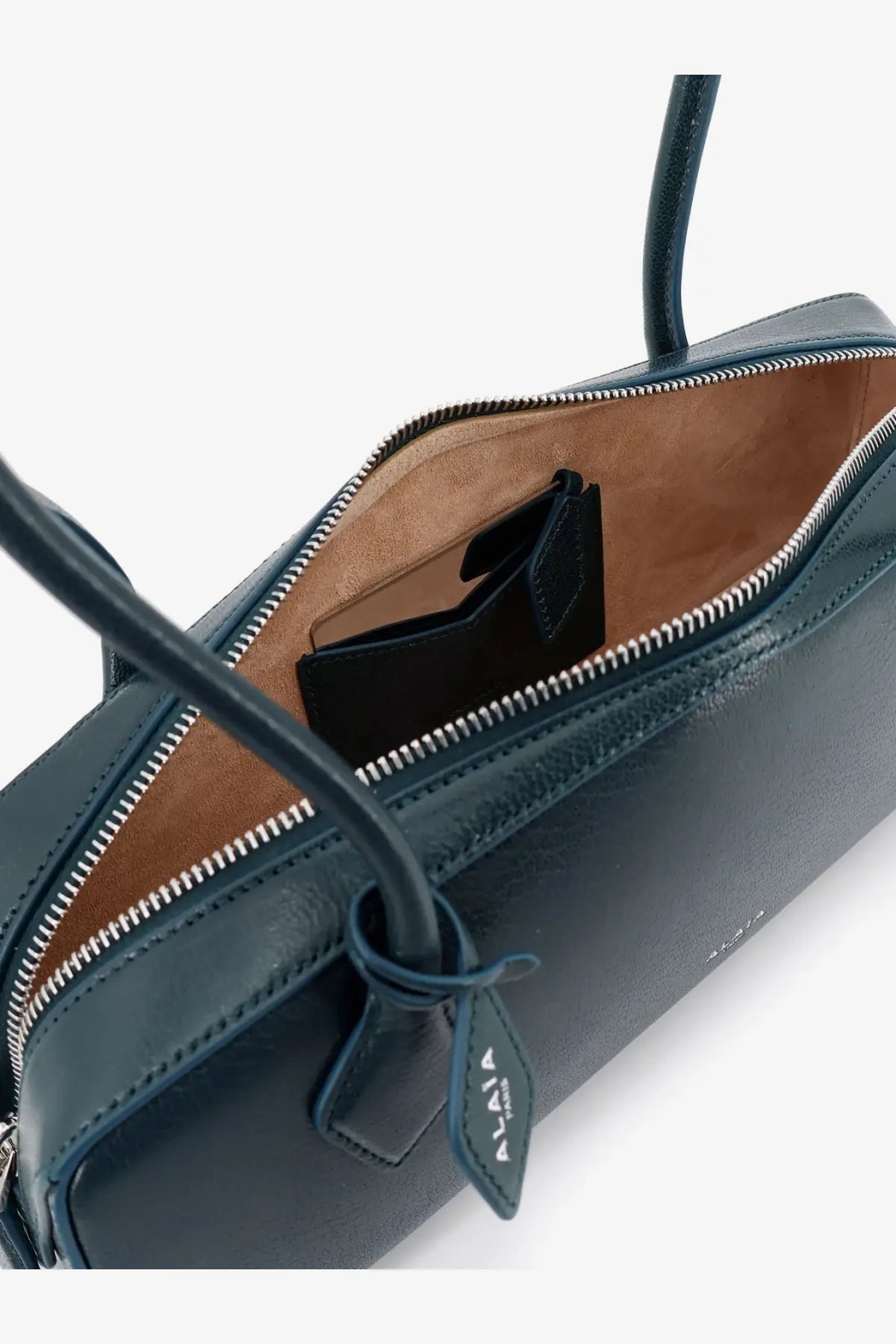 Alaïa women’s leather shoulder bag in dark teal with tan interior and silver zipper belupaon design