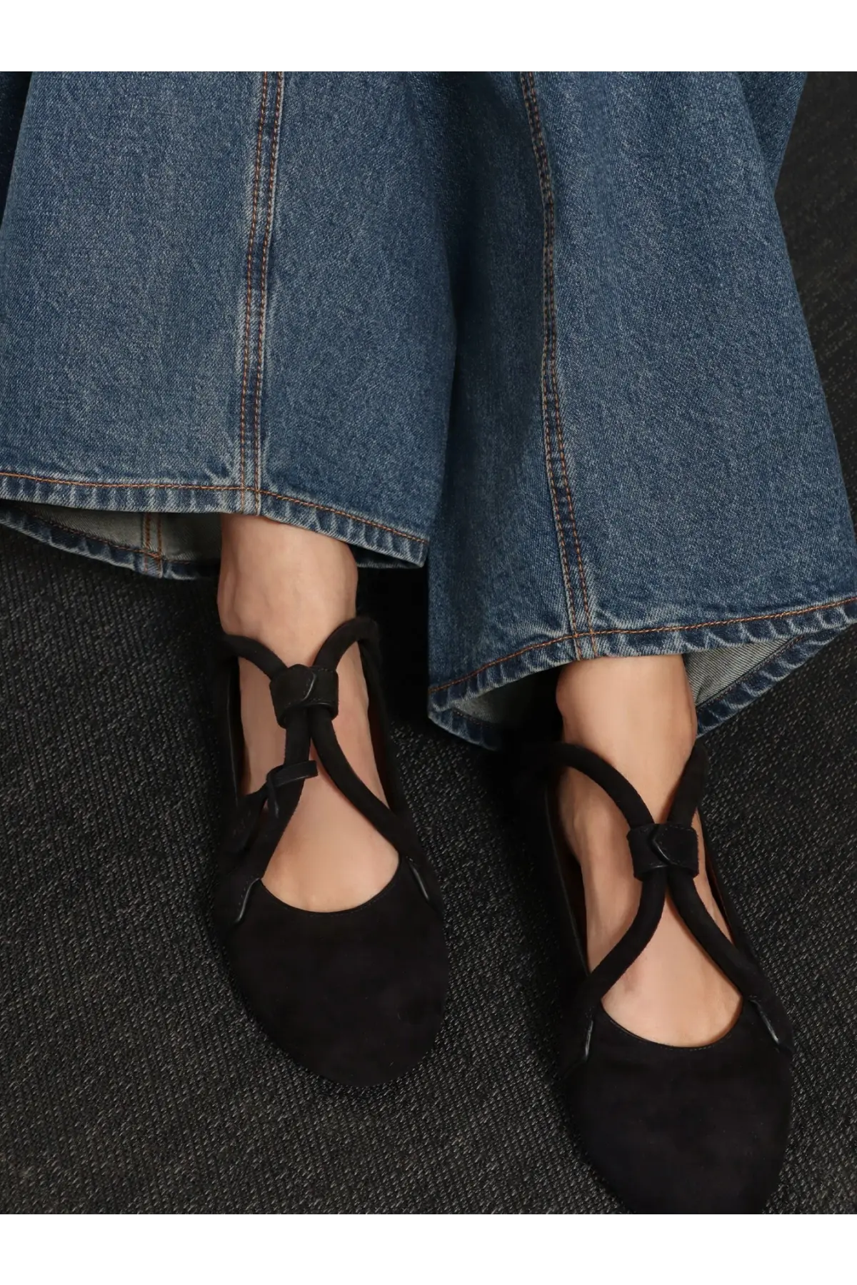 Alaïa women’s le teckel suede ballet flats in black with crisscross ankle straps and tied bow detail