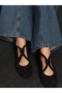 Alaïa women’s le teckel suede ballet flats in black with crisscross ankle straps and tied bow detail