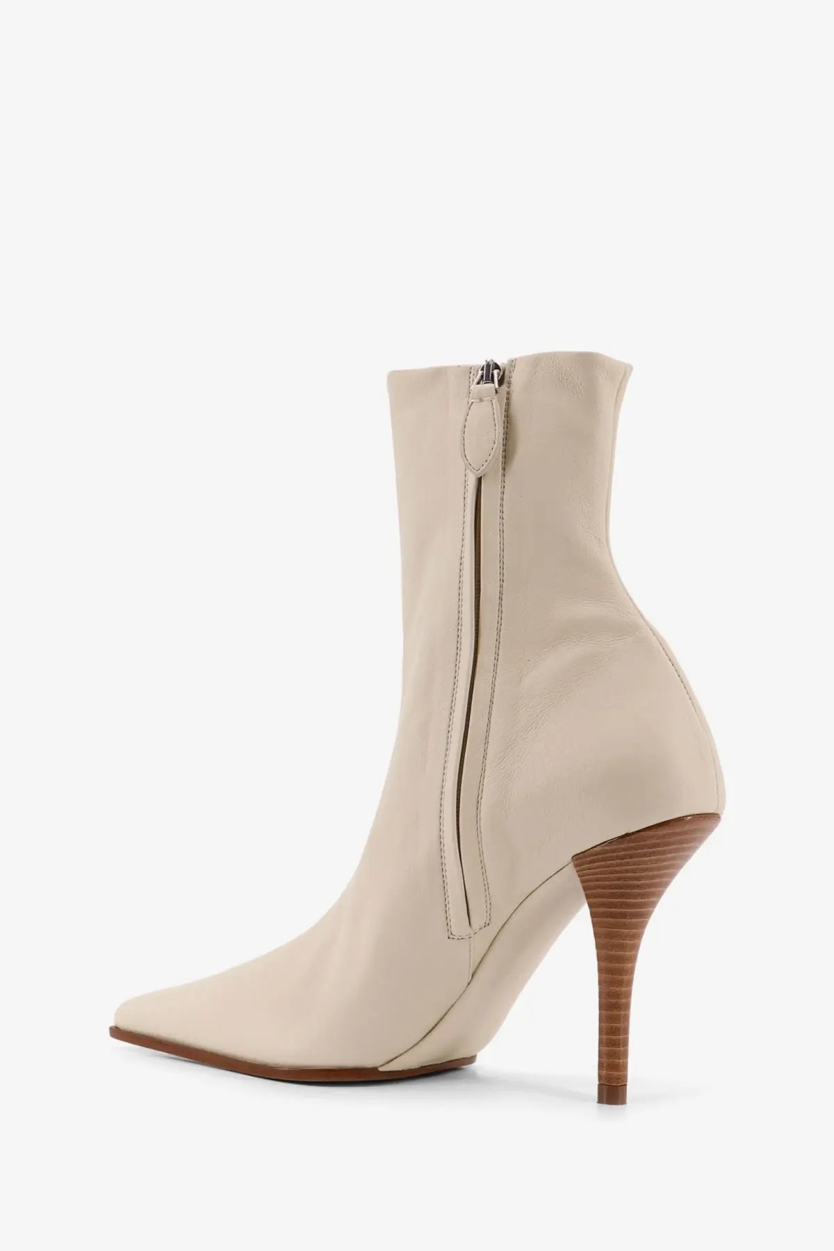 Alaïa women’s beige leather ankle boot with a slender textured wooden heel and pointed toe
