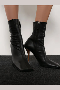 Alaïa women’s black leather ankle boots with a sleek square-toe design and slender high heel