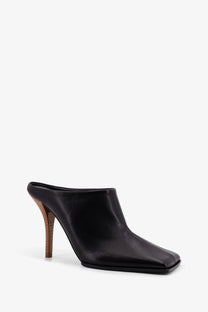 Alaïa women’s black leather sandals featuring a square toe and wooden heel mule shoe design