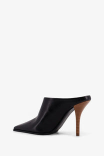 Alaïa women’s black leather mule sandals with a wooden heel shown from the back side