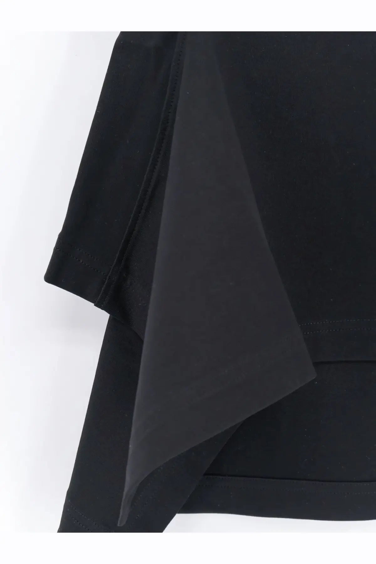 Alaïa women’s paneled cotton shirt in black showing smooth matte fabric with clean stitching along the edge