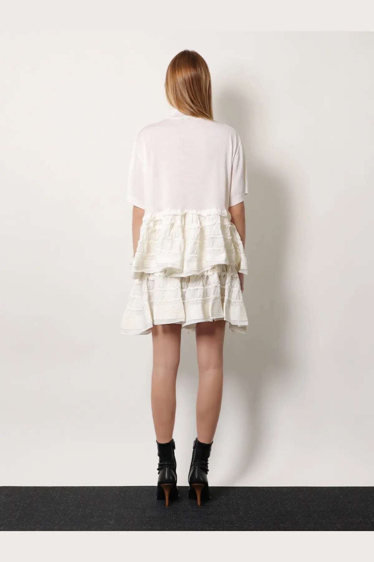 Alaïa women’s white tiered dress with sheer short sleeves and ruffled textured skirt in virgin wool blend