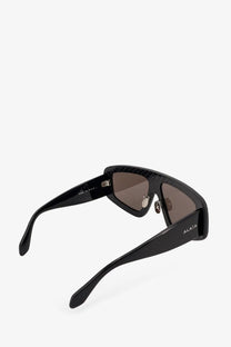 Alaiia women’s texturized acetate sunglasses in black with a glossy frame and brown gradient lenses