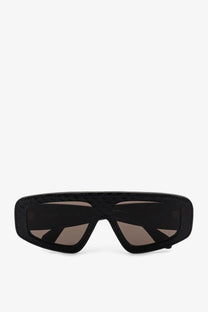 Alaïa women’s black sunglasses with textured woven acetate frame and dark brown gradient lenses