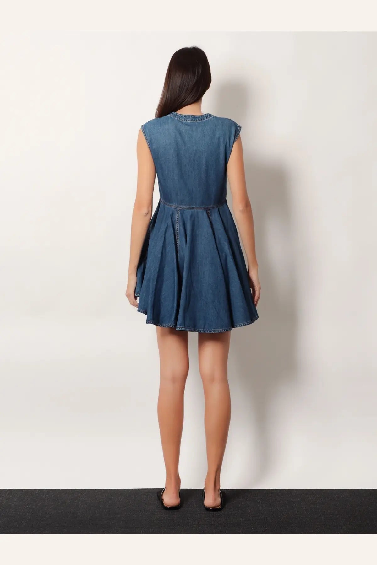 Alaïa women’s black sleeveless denim wrap dress with flared skirt and decorative stitching along the neckline