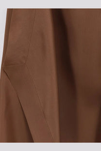 A close-up of smooth rich brown silk fabric with clean stitching on the Alberta Ferretti women’s long dress