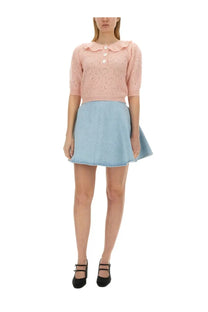 A soft pink knitted top with lace pattern and buttons paired with light blue denim skirt from alessandra rich women’s hearts jersey blue