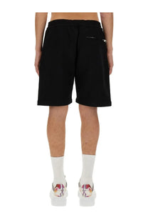 Back view of alexander mcqueen men’s black cotton bermuda shorts with rear zip pocket and elastic waistband