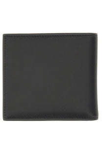 Black leather Alexander McQueen men’s bifold wallet with precise stitching along the edges