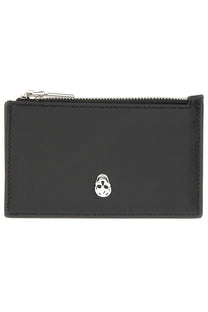 Black leather zippered card case with silver skull emblem by Alexander McQueen for men