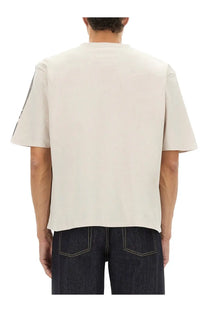 Alexander McQueen men’s beige short-sleeved cropped t-shirt with subtle graphic on left sleeve in grey tone