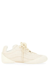 Alexander McQueen men’s flexion sneaker in cream-colored suede with a sleek modern design and subtle stitching details
