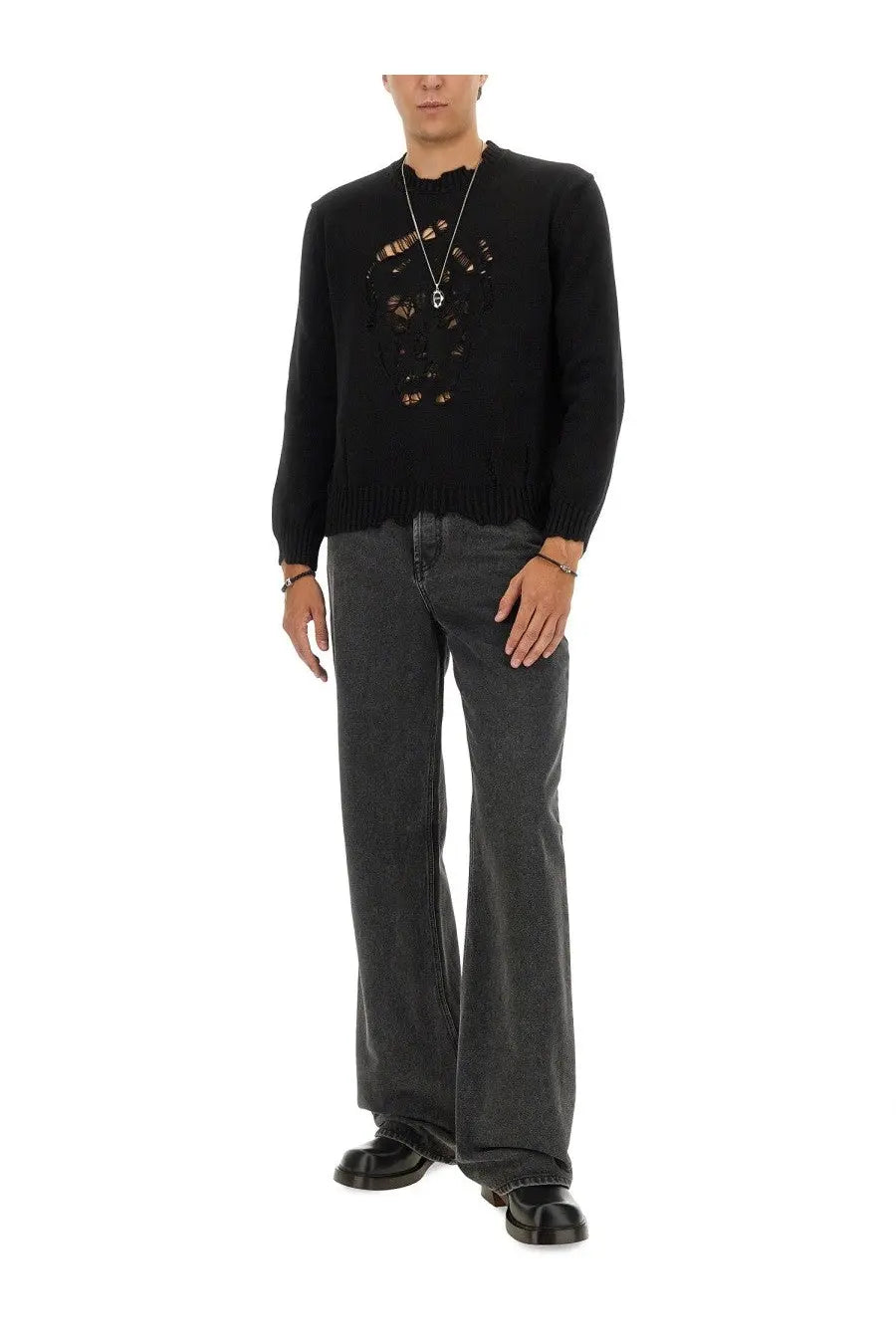 Black knit sweater with distressed embroidered skull design matched with alexander mcqueen mens baggy grey jeans