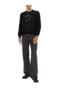 Black knit sweater with distressed embroidered skull design matched with alexander mcqueen mens baggy grey jeans
