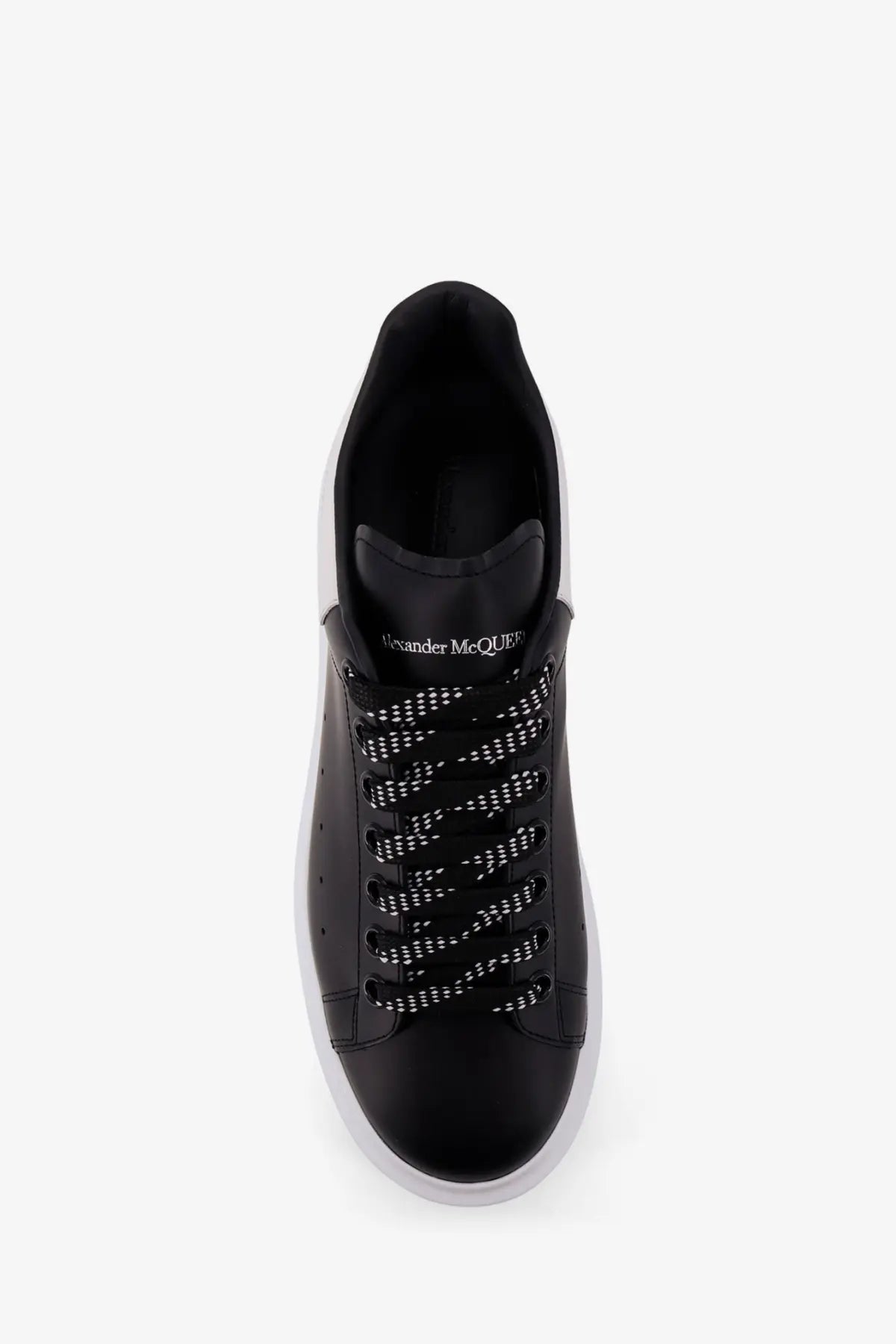 Alexander McQueen men’s low top black leather sneakers with white laces and contrasting white sole